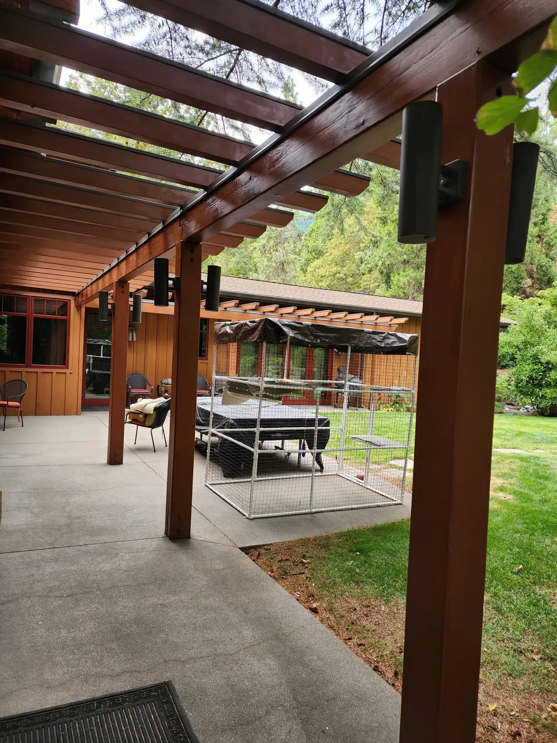 Deck Painting Stained wood pergola and arbor structure on a residential property