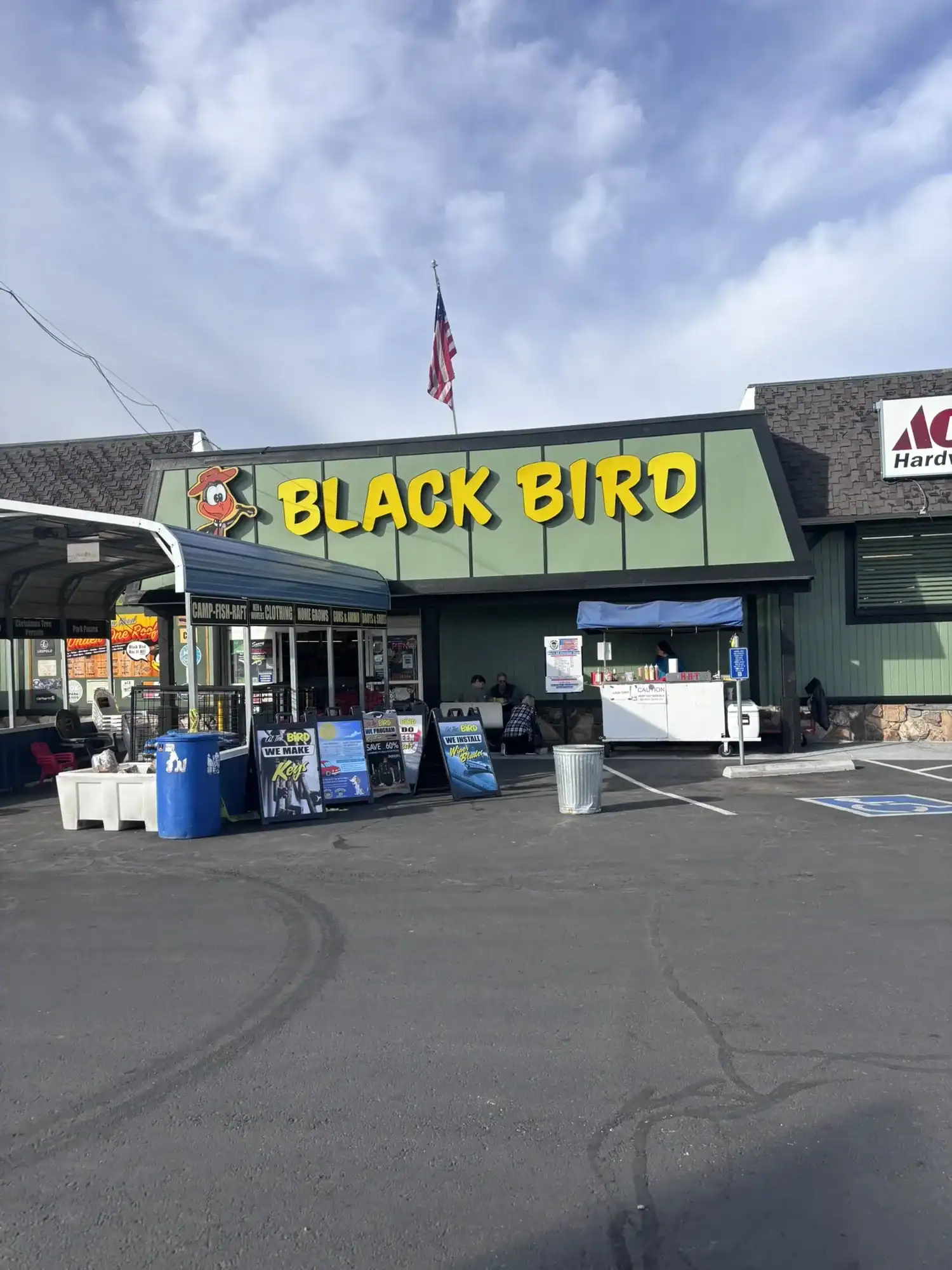 97B4DCC6-F42F-46AD-BD24-A73E5E9D7174_1_102_o Black Bird retail storefront freshly painted in dark green with black trim and a bold yellow sign fascia