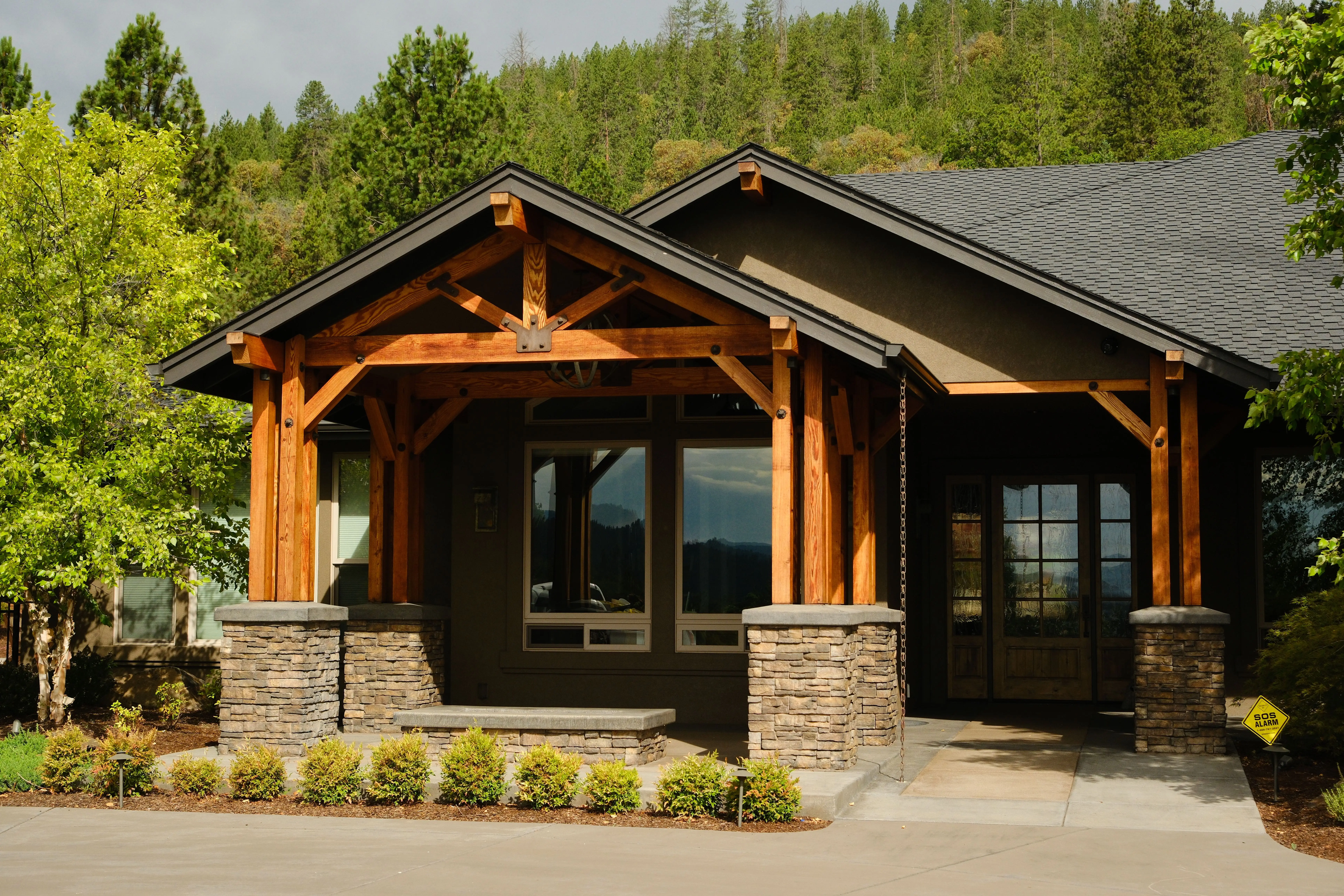 Modern Home Exterior Painting and Curb Appeal Beautifully painted modern residential house exterior with neutral tones, stone pillars, and wooden beams.