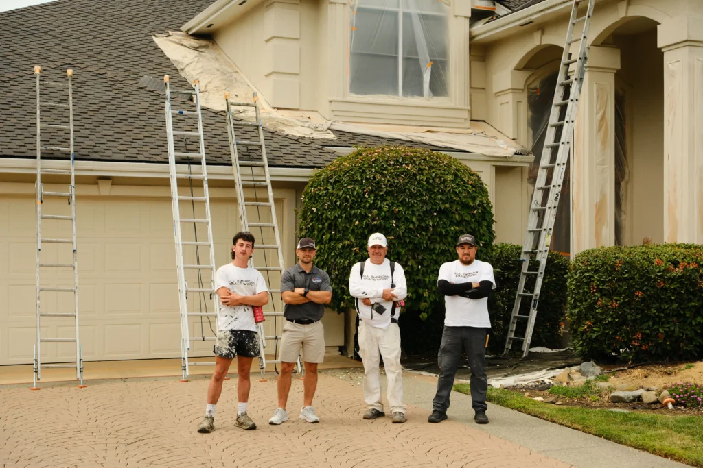 Professional Painting Crew for Residential Exterior Projects Exterior painting team standing in front of a prepared stucco home